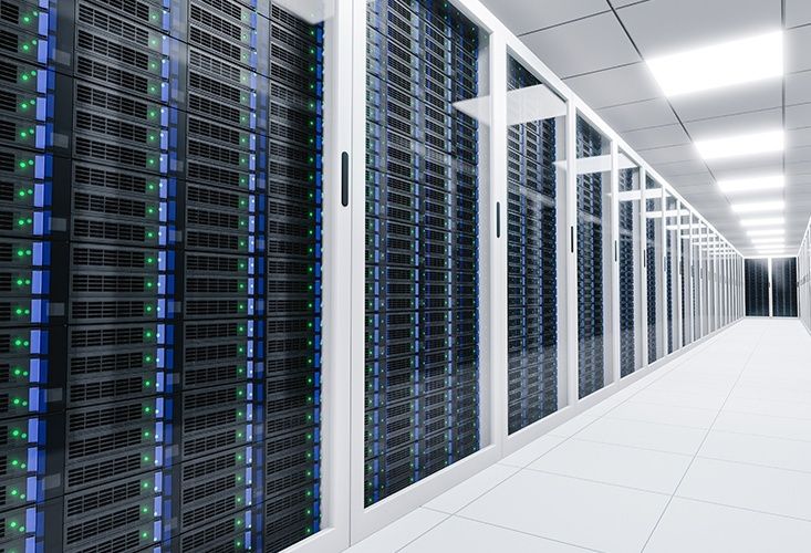 Rows of illuminated server racks in a bright data center